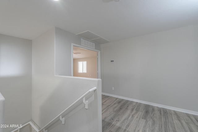 hallway with light hardwood / wood-style floors