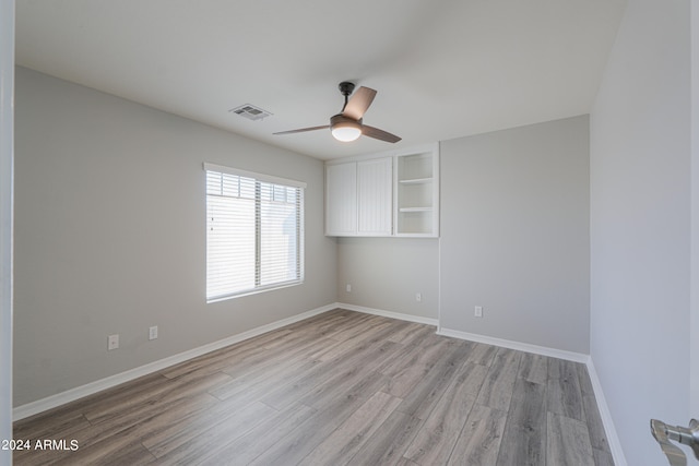 unfurnished room with ceiling fan and light wood-type flooring