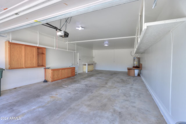 garage with a garage door opener and electric water heater