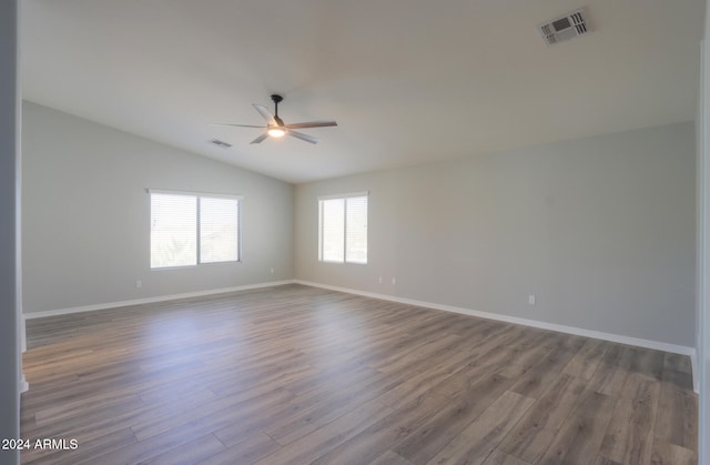 unfurnished room with ceiling fan, vaulted ceiling, and wood-type flooring