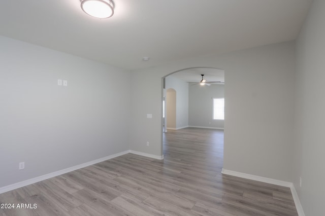 empty room featuring ceiling fan and light wood-type flooring