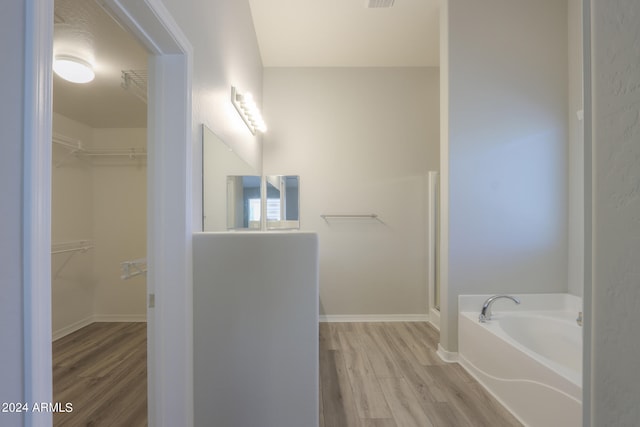 bathroom featuring a bathing tub and hardwood / wood-style floors