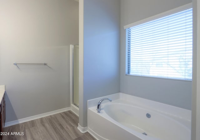 bathroom featuring hardwood / wood-style floors, vanity, and independent shower and bath