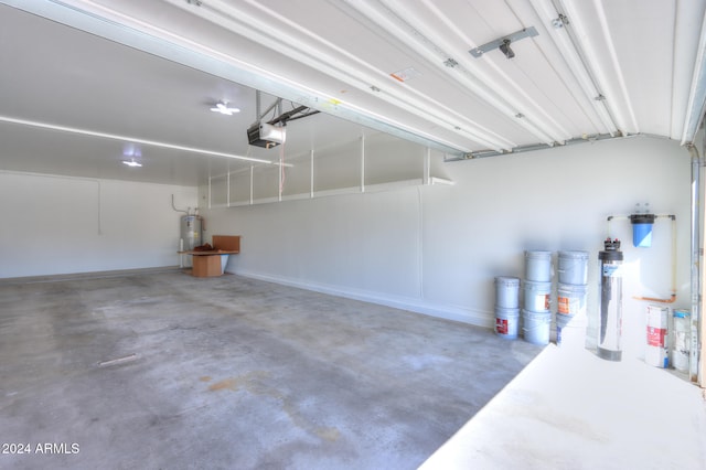 garage with a garage door opener and water heater