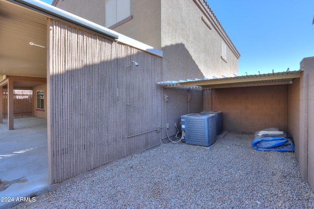 view of side of home with cooling unit and a patio area