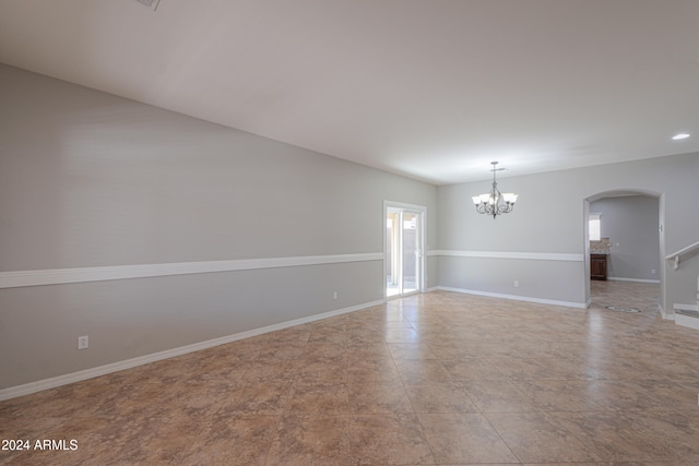 empty room featuring a chandelier