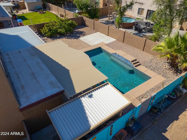 view of pool featuring a jacuzzi and a patio area