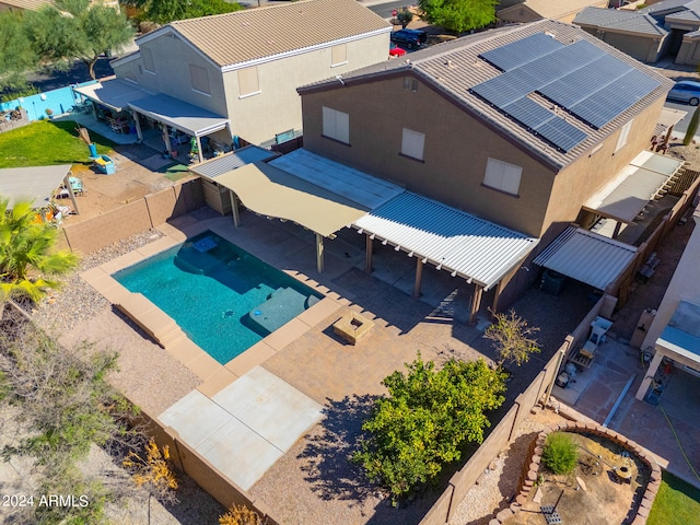 view of swimming pool featuring a jacuzzi and a patio