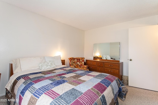 bedroom with a textured ceiling and light carpet