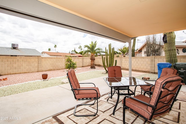 view of patio with outdoor dining space and a fenced backyard