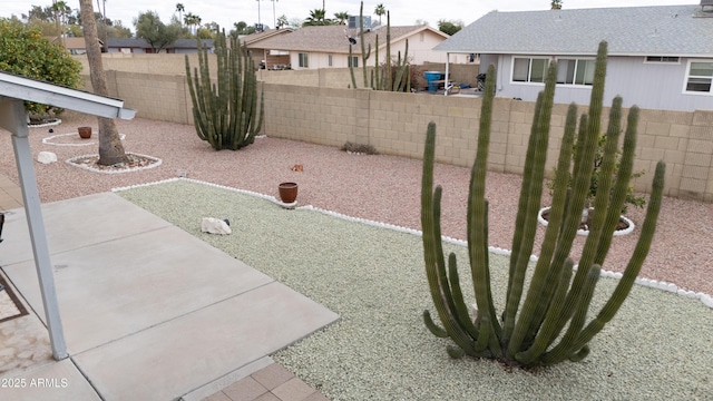 view of yard with a residential view, a patio, and a fenced backyard