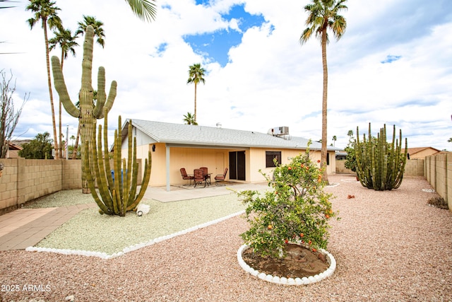 back of property with a patio area and a fenced backyard