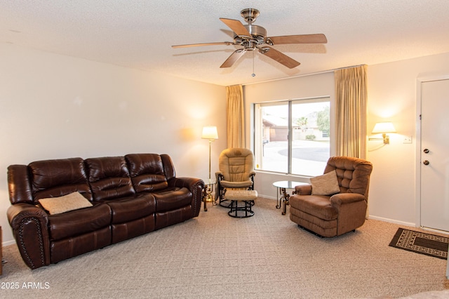 carpeted living area with baseboards, a textured ceiling, and ceiling fan