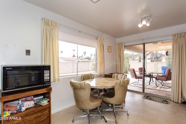 dining area with baseboards and heating unit