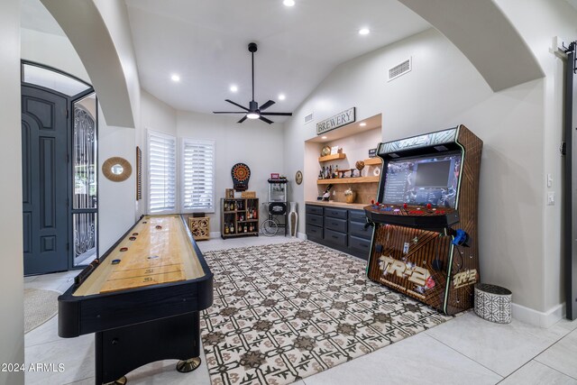 game room featuring lofted ceiling and ceiling fan