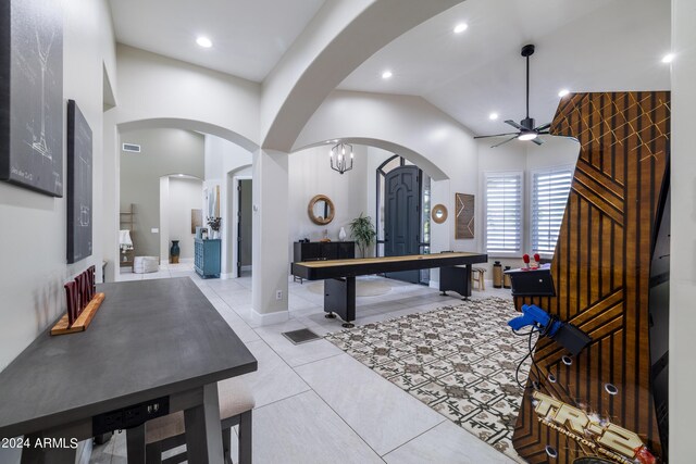 kitchen with ceiling fan with notable chandelier, lofted ceiling, and light tile patterned floors