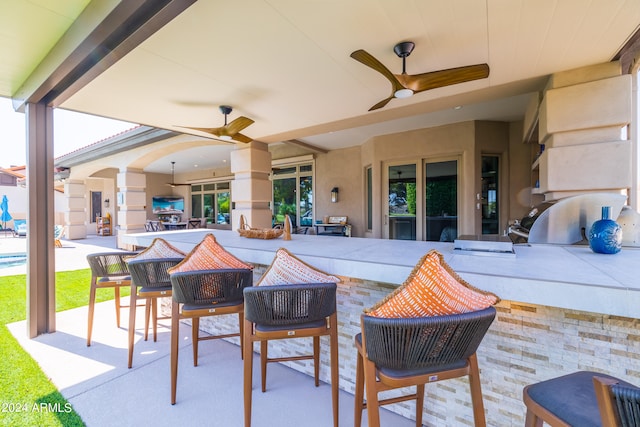 view of patio / terrace featuring ceiling fan, a swimming pool, and outdoor lounge area