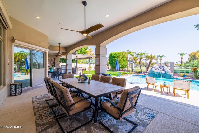 view of patio / terrace featuring pool water feature and ceiling fan