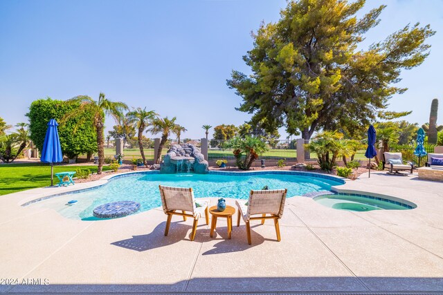 view of swimming pool with a patio and an in ground hot tub