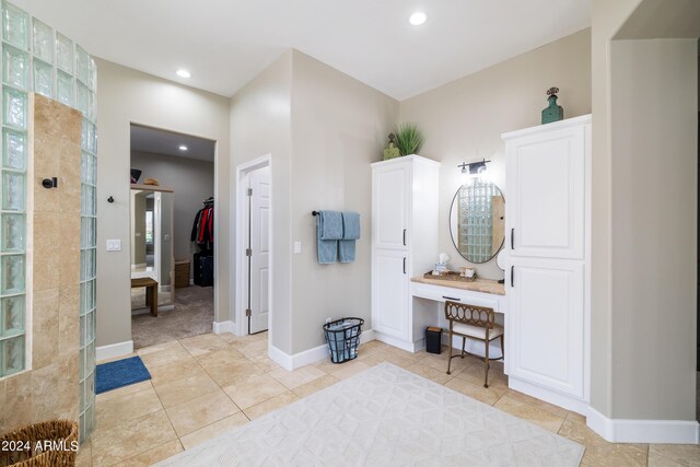 bathroom with walk in shower and tile patterned floors