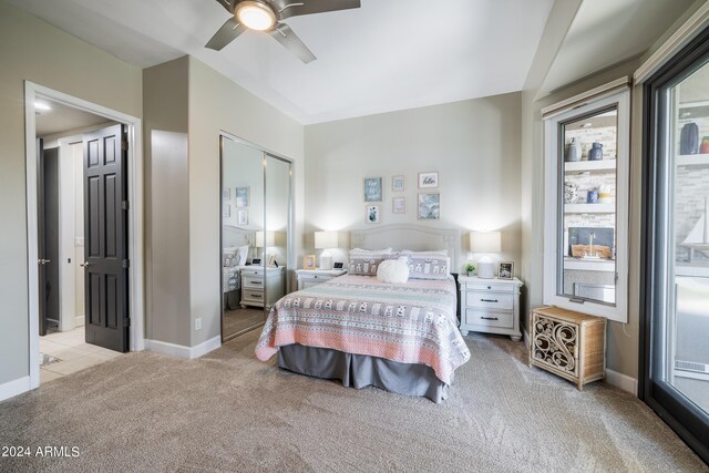 bedroom featuring light colored carpet, ceiling fan, a closet, and access to outside