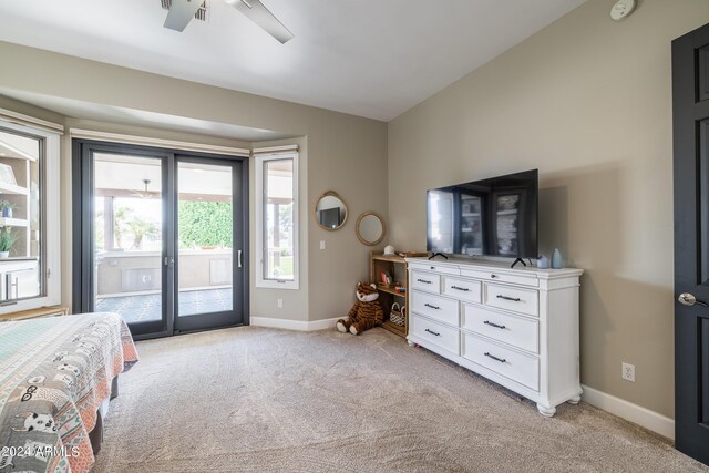 bedroom featuring lofted ceiling, ceiling fan, multiple windows, and access to outside