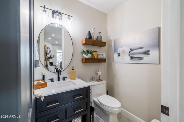 bathroom with vanity, toilet, and tile patterned floors