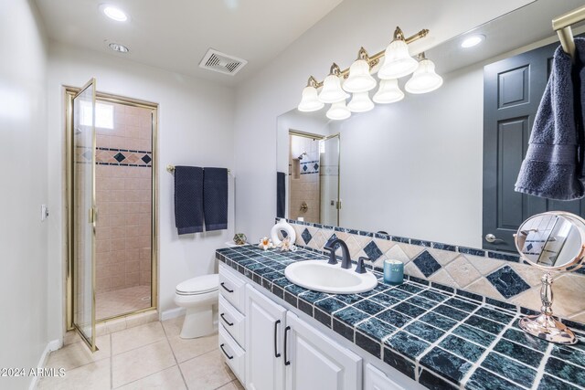 bathroom with an enclosed shower, tile patterned floors, toilet, tasteful backsplash, and vanity