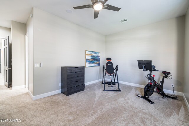 workout room with light carpet and ceiling fan