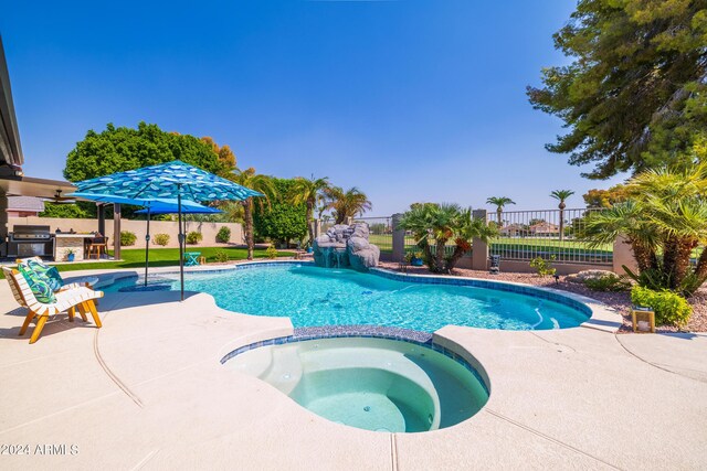 view of pool featuring area for grilling, a patio, and an in ground hot tub