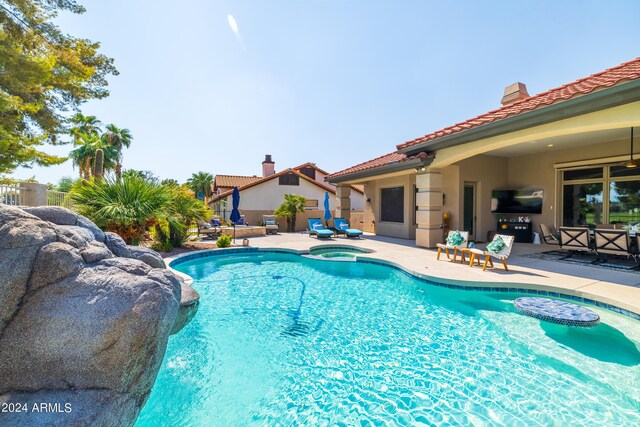 view of pool featuring a patio area and an in ground hot tub