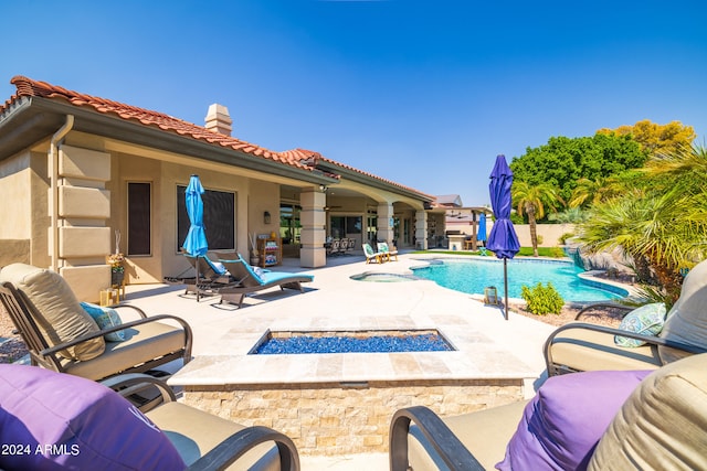 view of pool with a fire pit and a patio