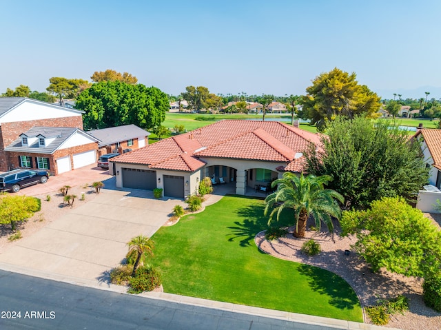 mediterranean / spanish-style house with a front lawn and a garage