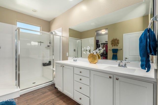 bathroom featuring vanity, walk in shower, and hardwood / wood-style flooring