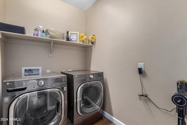 washroom featuring washer and dryer and hardwood / wood-style flooring