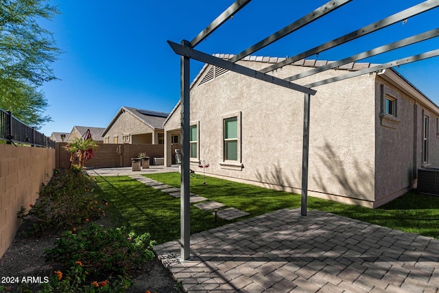 rear view of property with a patio, cooling unit, a yard, and a pergola