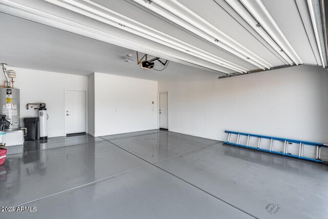 garage featuring a garage door opener and water heater