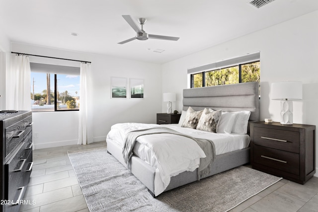 bedroom with multiple windows and ceiling fan