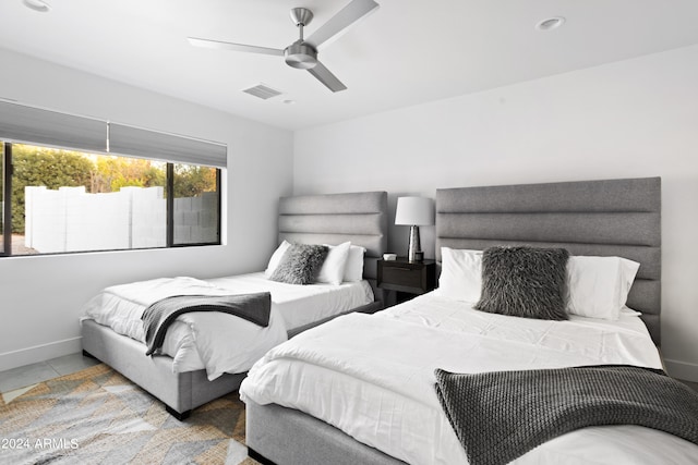 bedroom with ceiling fan and light tile patterned floors