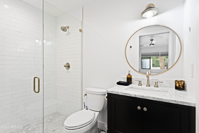 full bathroom featuring toilet, a shower stall, vanity, and a ceiling fan