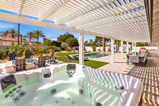 view of patio / terrace featuring an outdoor fire pit, a fenced backyard, and a hot tub
