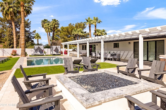 view of pool with a fire pit, a yard, and a patio area