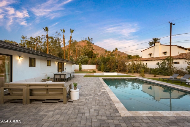 view of swimming pool featuring a patio area and a mountain view