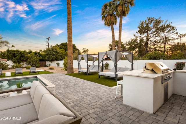 patio terrace at dusk with a fenced in pool, an outdoor hangout area, and area for grilling