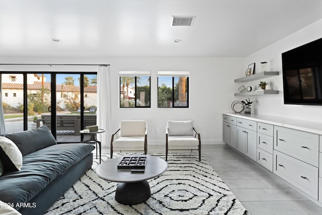 living room featuring baseboards and visible vents