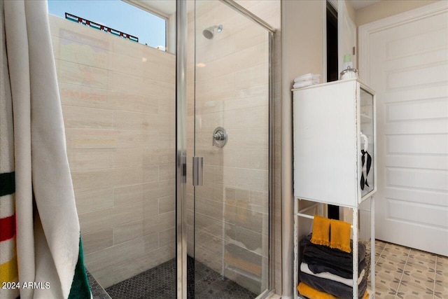 bathroom with a shower with door