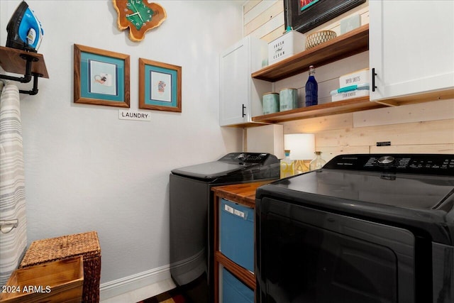 laundry room featuring cabinets and washing machine and clothes dryer