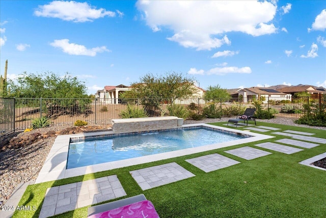 view of pool featuring pool water feature and a yard