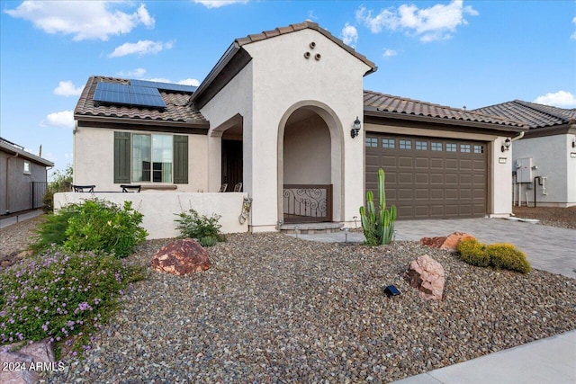 view of front of home featuring a garage and solar panels