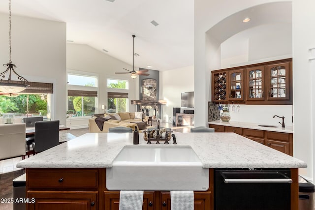 2058 E Marlene Dr, Gilbert, AZ 85296 - kitchen with high vaulted ceiling, a ceiling fan, open floor plan, light stone countertops, and glass insert cabinets